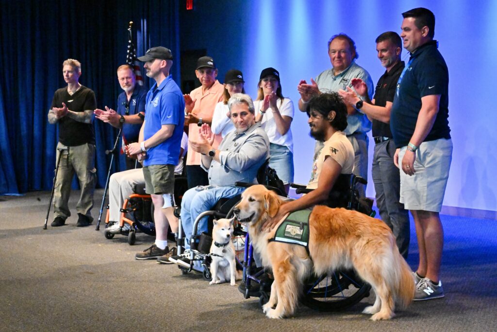 Able Flight's new pilots and sponsors of scholarships on stage at EAA AirVenture as the new pilots get their wings.